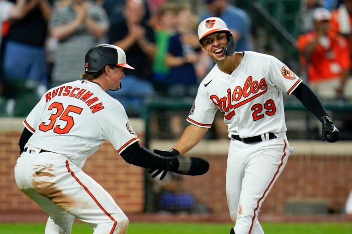 Baltimore Orioles’ Ramon Urias (29) is greeted near home plate by Adley Rutschman (35) after Urias’ two-run home run off Tampa Bay Rays relief pitcher Colin Poche scored both of them during the eighth inning of a baseball game, Tuesday, July 26, 2022, in Baltimore. The Orioles won 5-3.